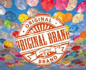 Original Brand icon in a sky of colored umbrellas representing the uniqueness of brands.